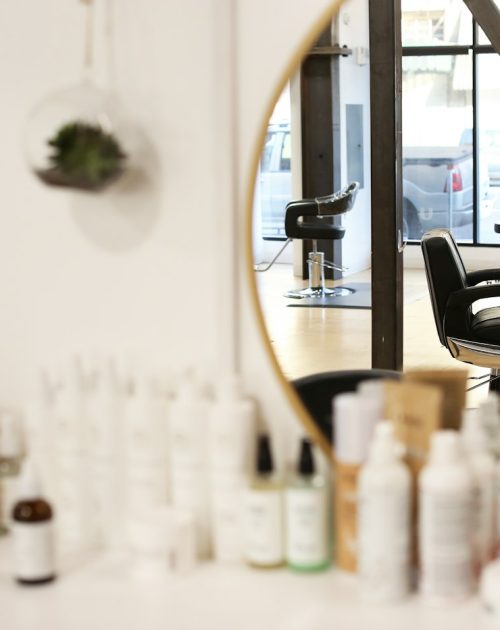 Salon chair beside a mirror