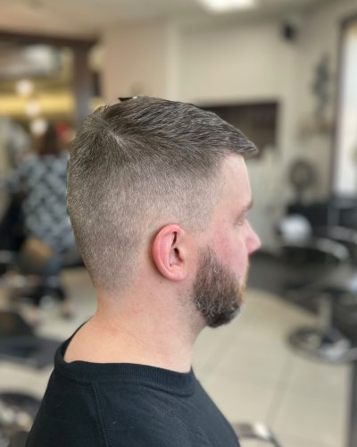 Man with a short haircut and shaped beard