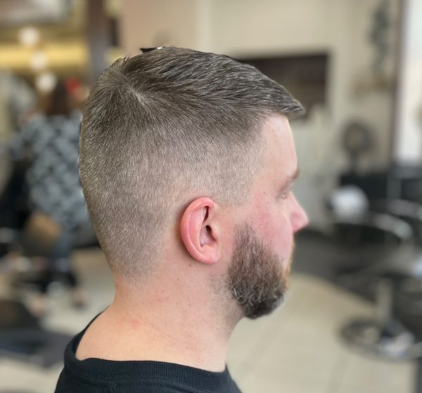 Man with a short haircut and shaped beard