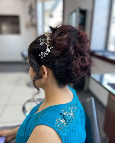 Updo with curls and a decorative hair piece