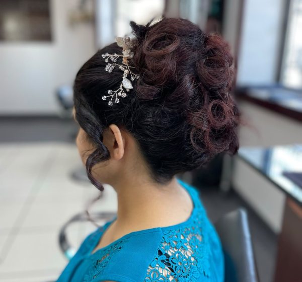 Updo with curls and a decorative hair piece