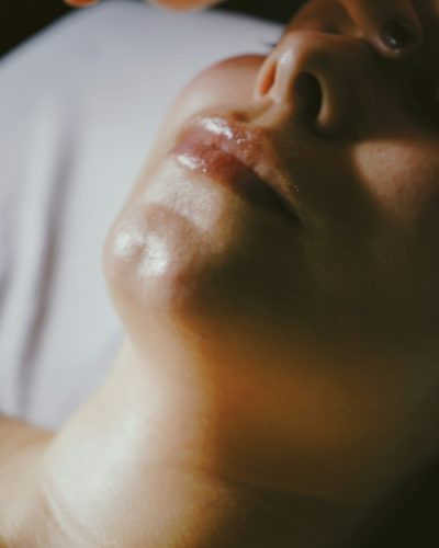 A woman getting a facial massage