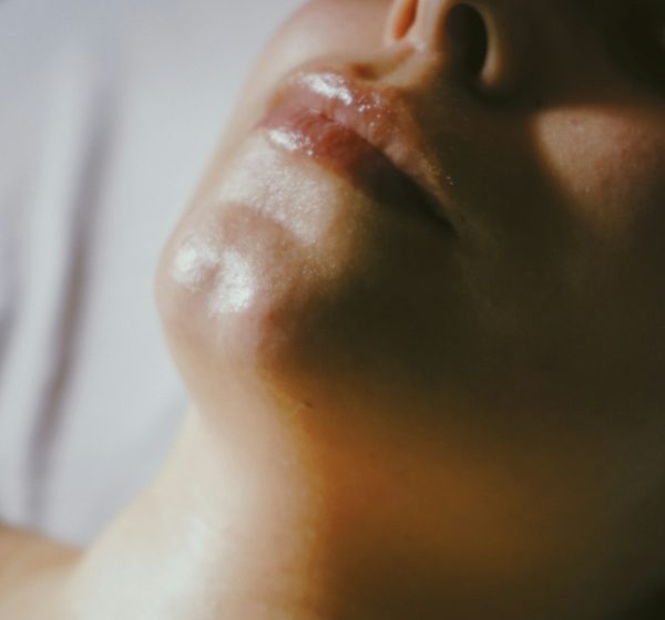 A woman getting a facial massage