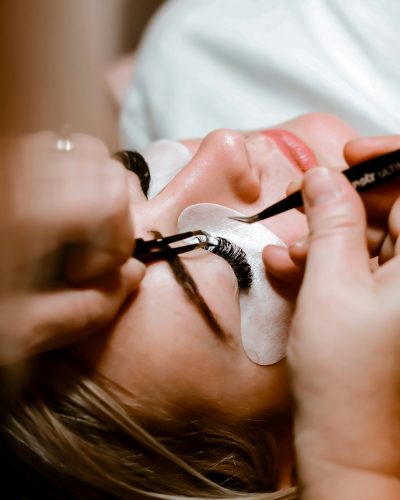 Eyelash extensions being applied with tweezers