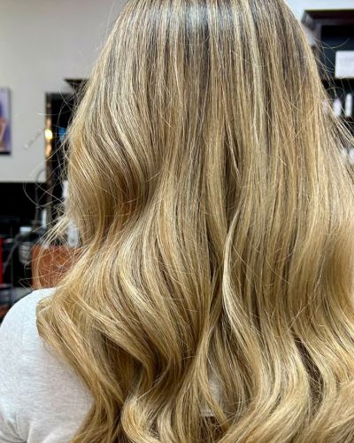 Long blonde hair styled in loose waves