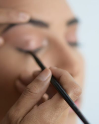 Makeup artist working on a client's eyes