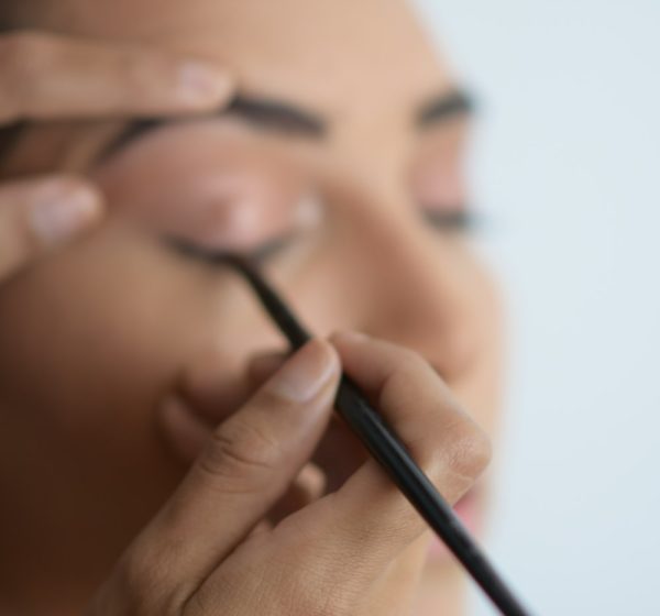 Makeup artist working on a client's eyes