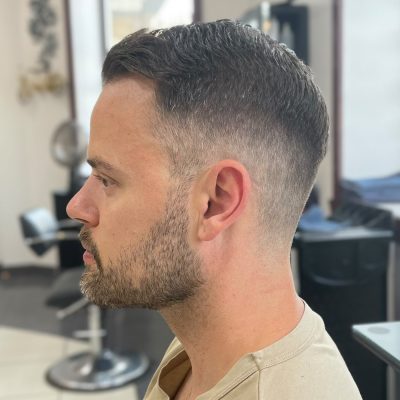 Man with a skin fade haircut and short beard