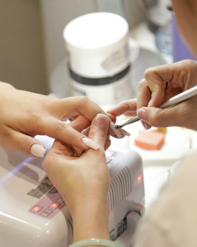 A woman getting her nails done at a salon