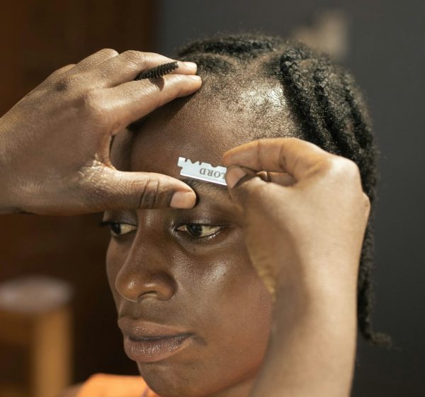 A woman's eyebrow being groomed